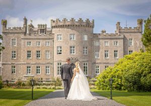 Married couple walking in castle grounds after wedding - Luxury Wedding Photography - Pink Lime Studios