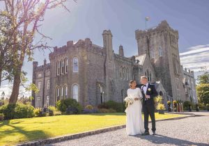 Married couple walking in castle grounds after wedding - Wedding Photography Sligo - Pink Lime Studios