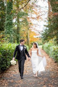 Autumn Wedding Photos - couple walking in the trees - Pink Lime Studios, Wedding Photographer Sligo
