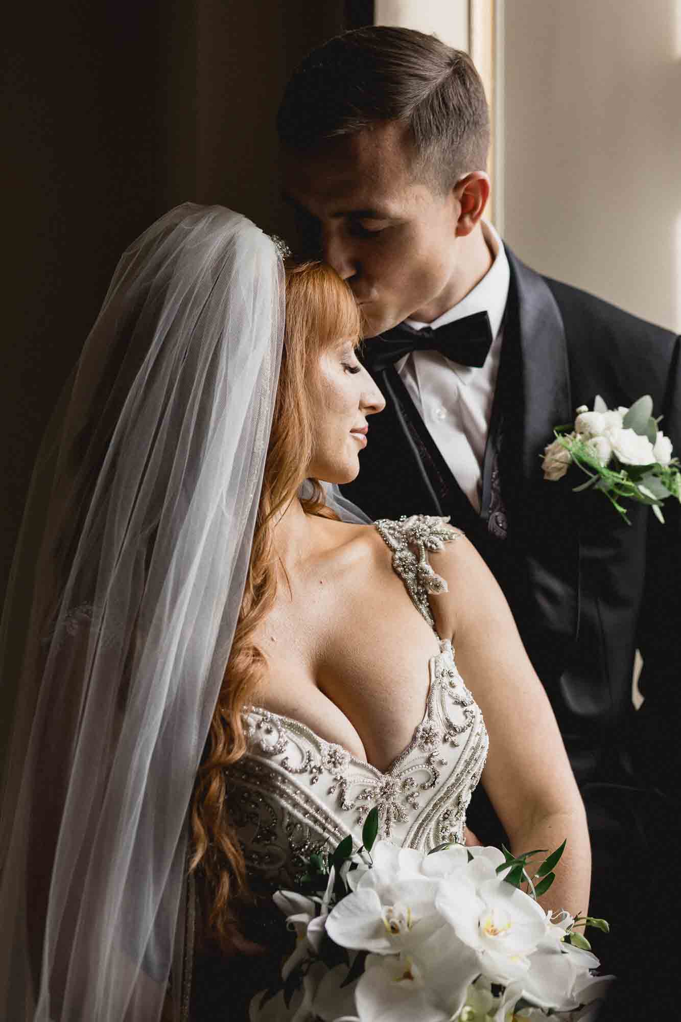 Groom kisses Bride in Window in Markree Castle