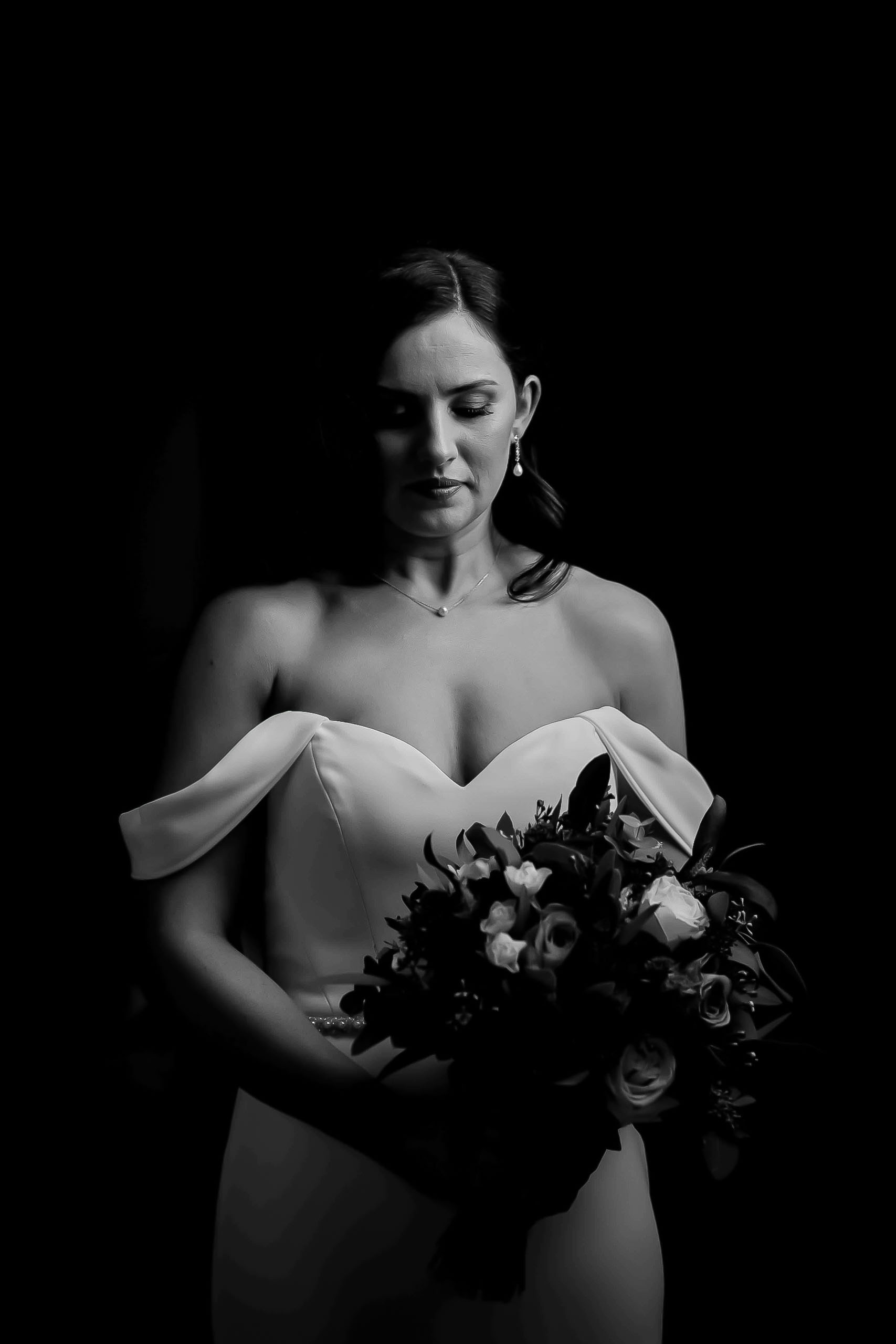 bride holding bouquet in a quiet moment of bridal preparations